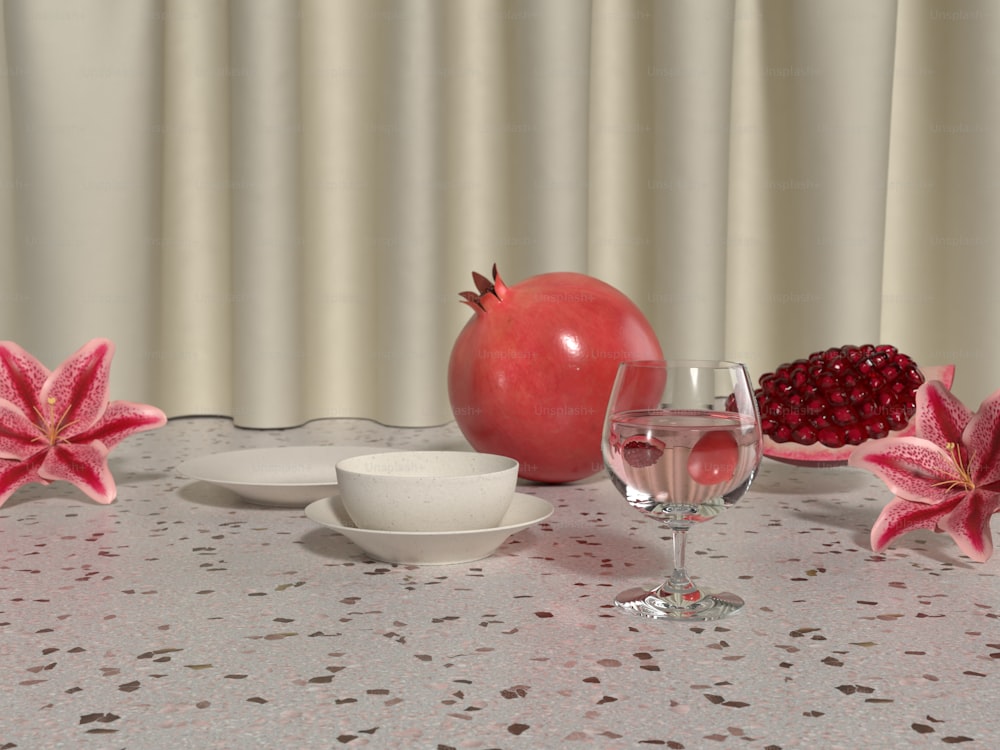 una mesa cubierta con una copa de vino y una granada