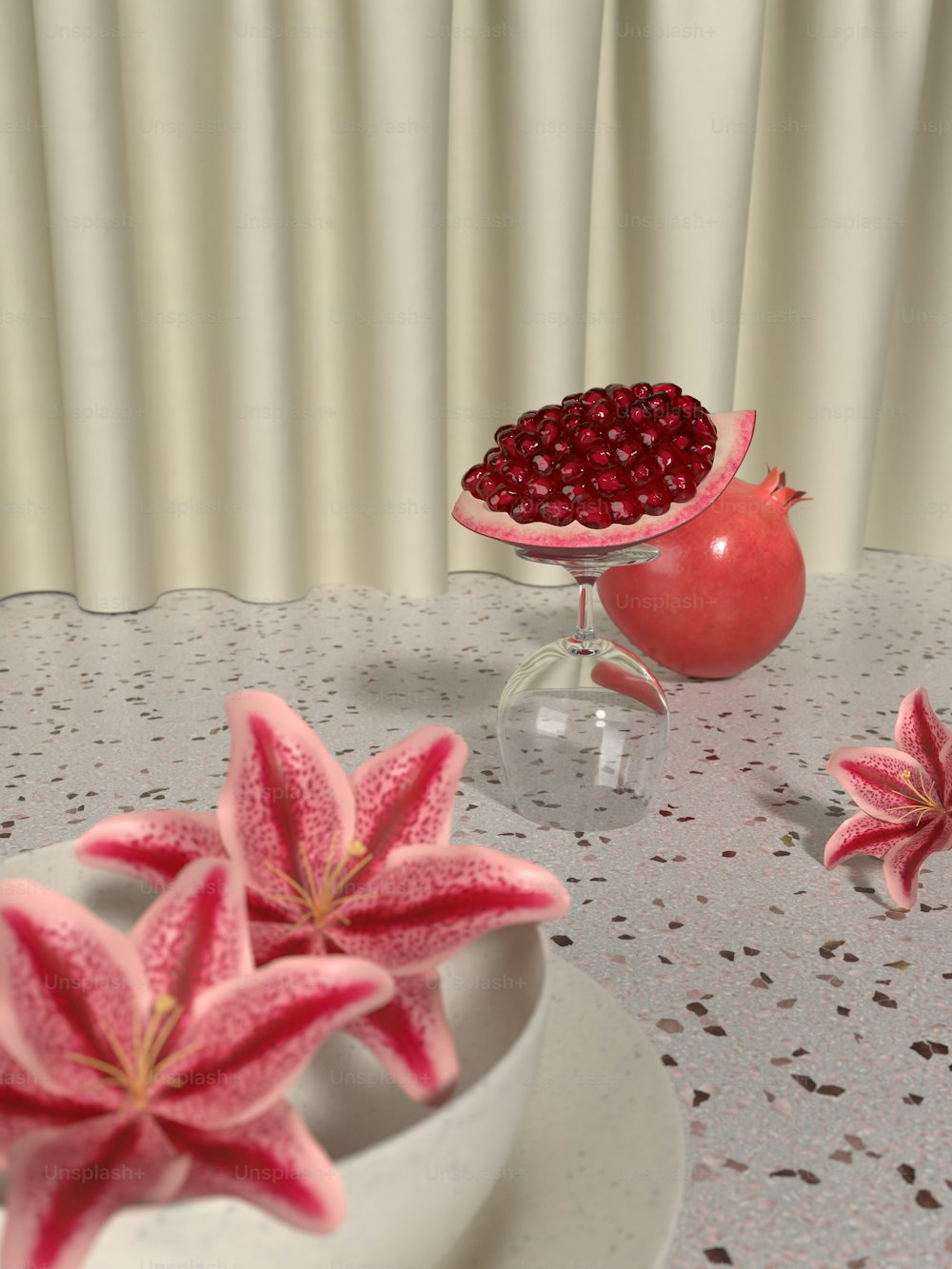 a table topped with a bowl of pomegranate and a vase filled with