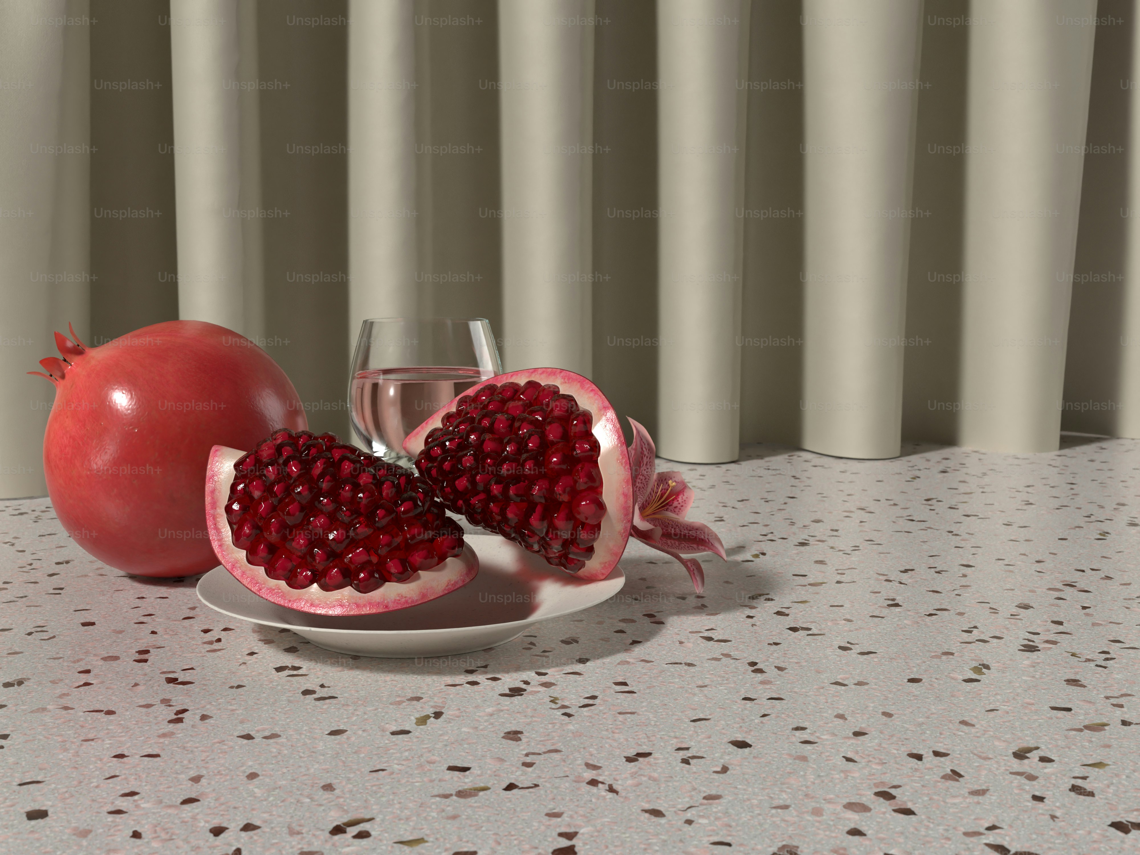 a pomegranate on a plate next to a glass of wine