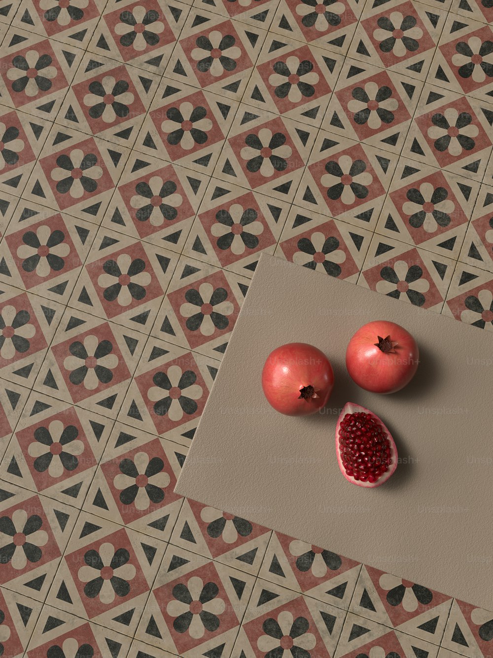 a couple of pomegranates sitting on top of a piece of paper