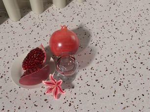 a pomegranate and a glass of water on a table