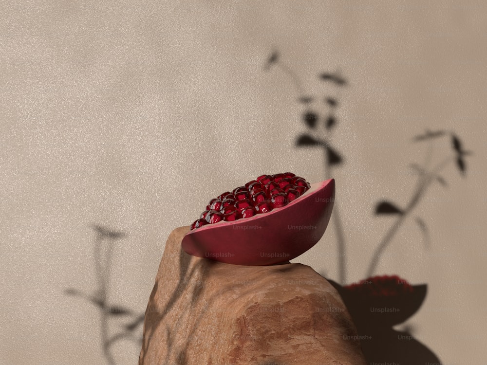 a red bowl with some pomegranates on top of it
