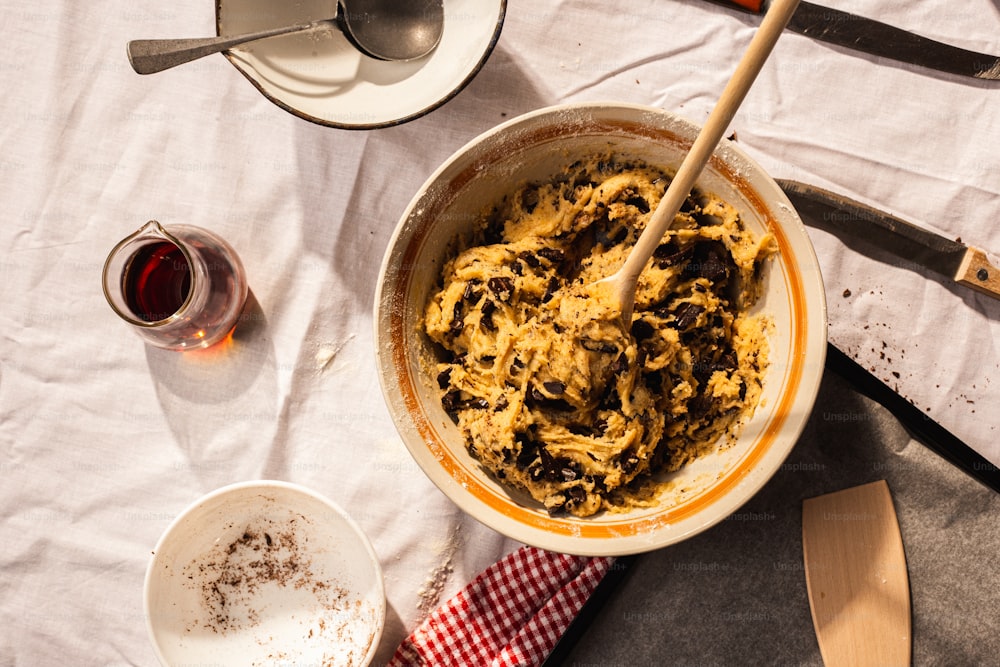 a bowl of food on a table with utensils