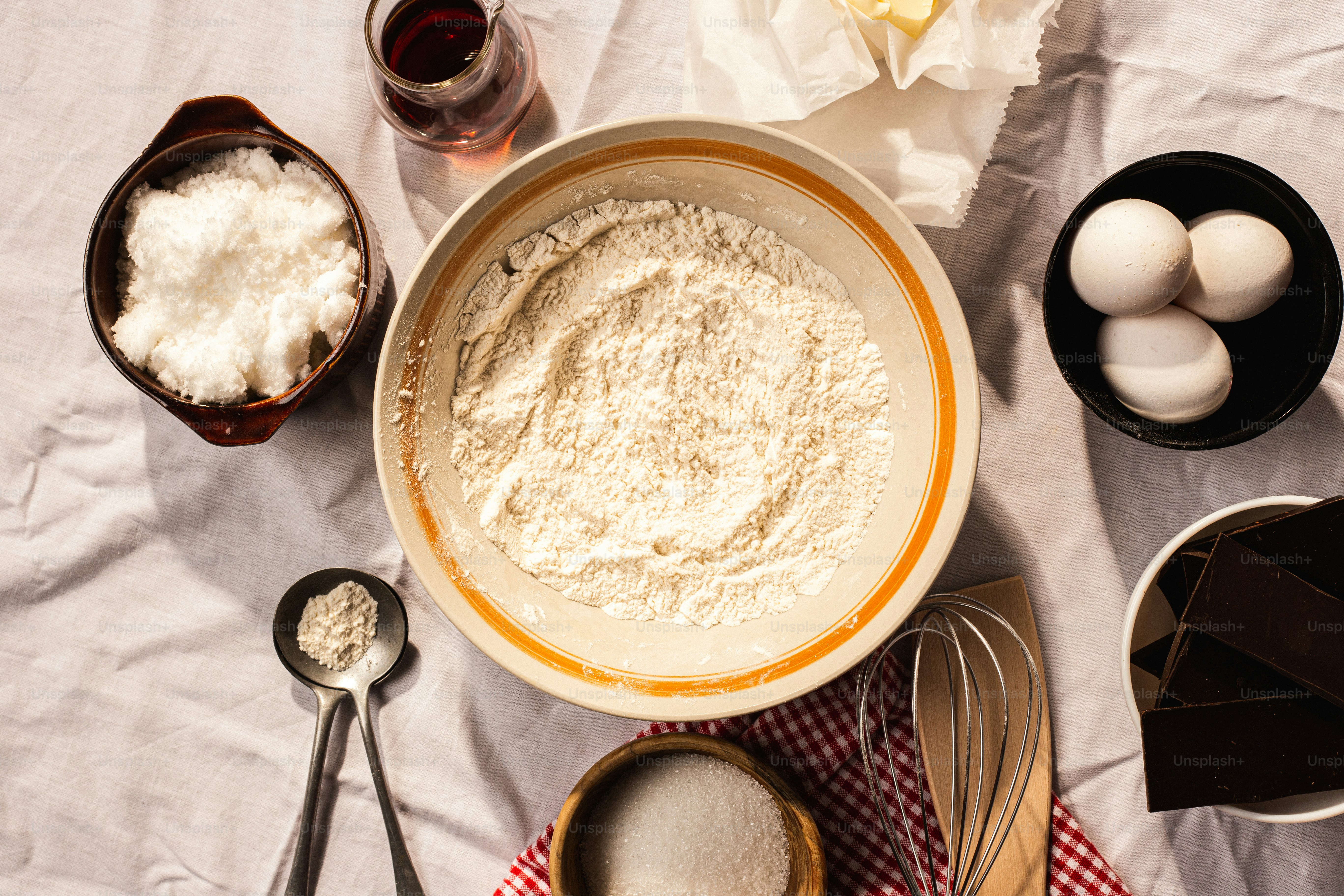 a table topped with bowls of food and utensils