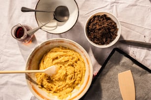 a bowl of hummus next to a bowl of chocolate