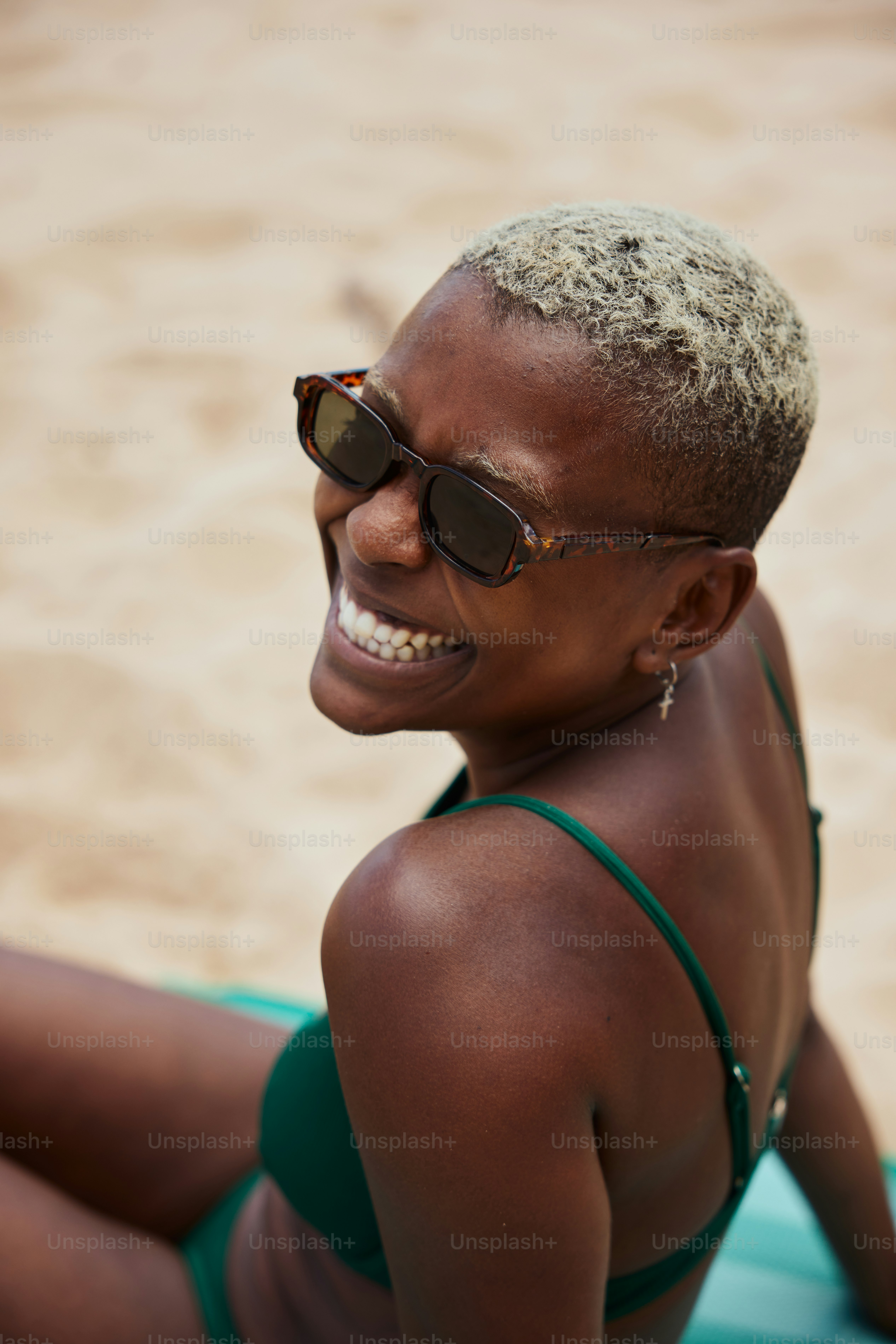 a woman in a bikini sitting on the beach