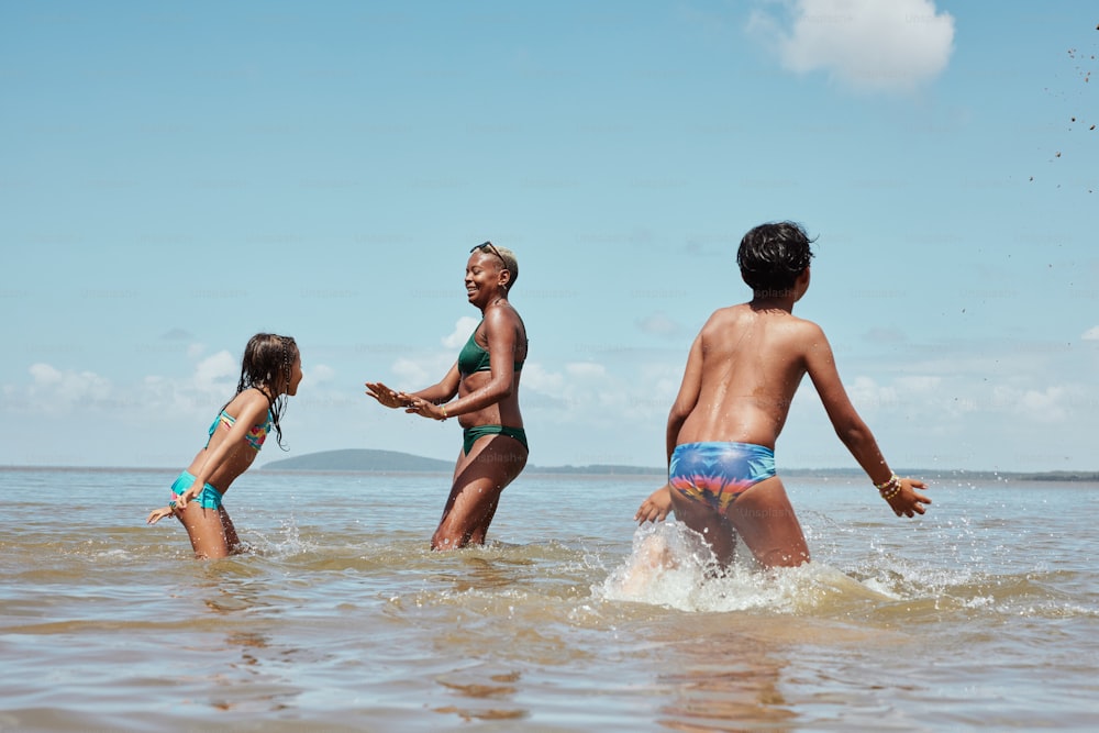 a group of people in the water playing with a frisbee