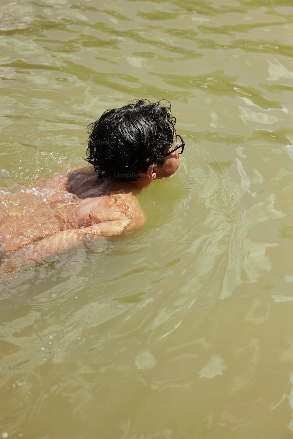 a man swimming in a body of water