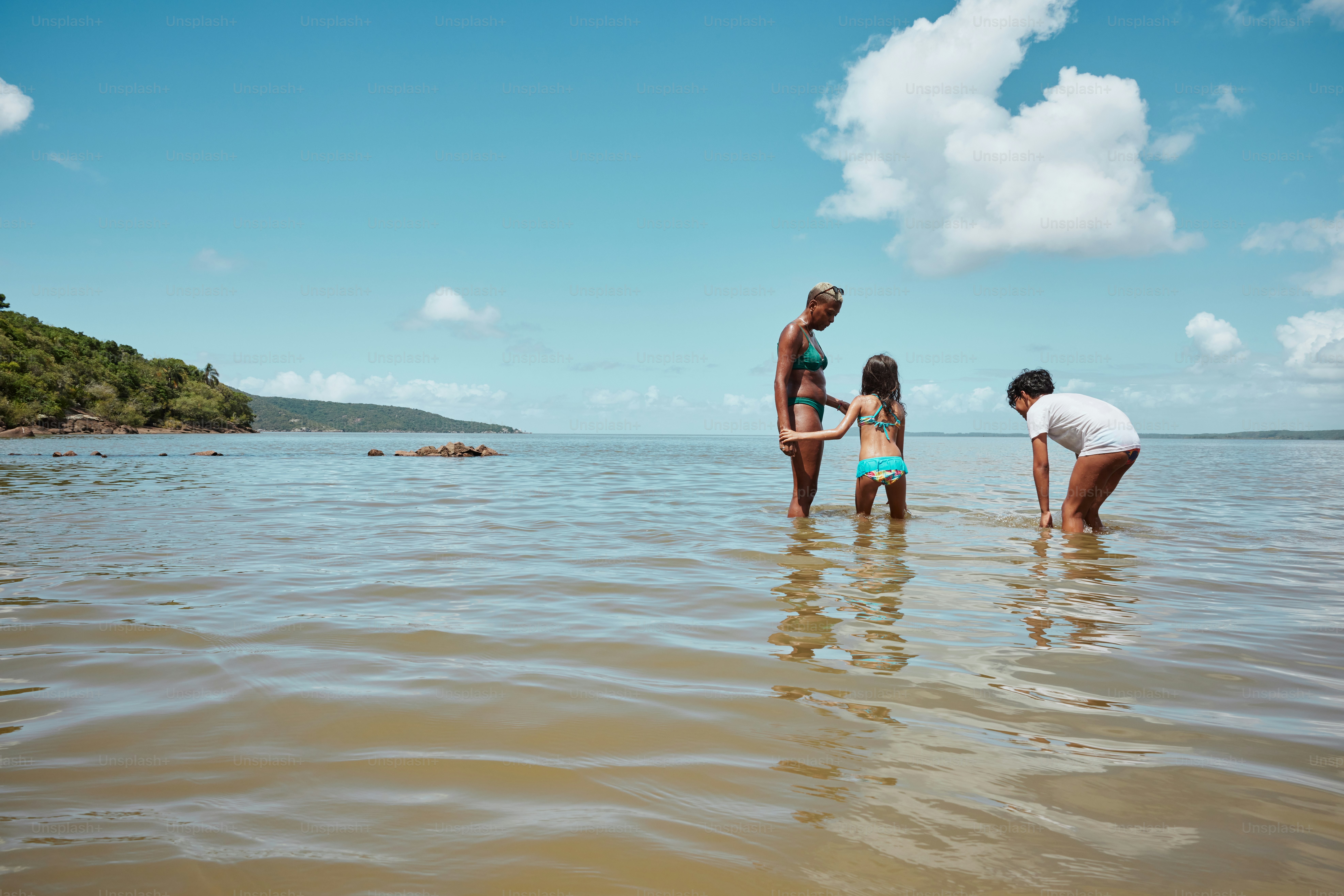 a group of people standing in a body of water