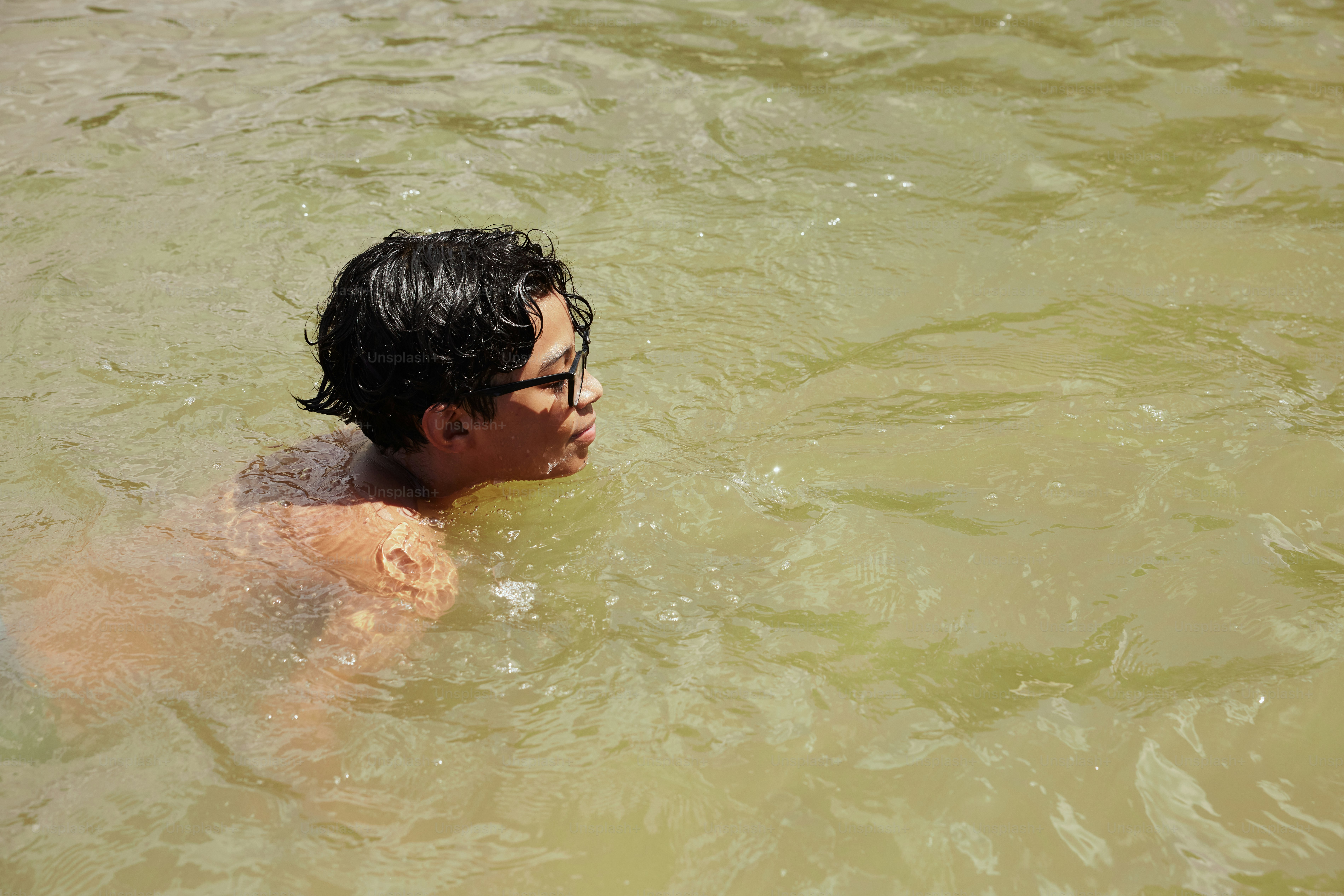 a man swimming in a body of water