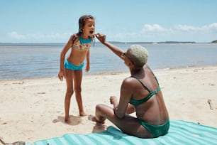a little girl in a bikini on the beach
