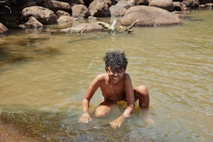 a young boy is playing in the water