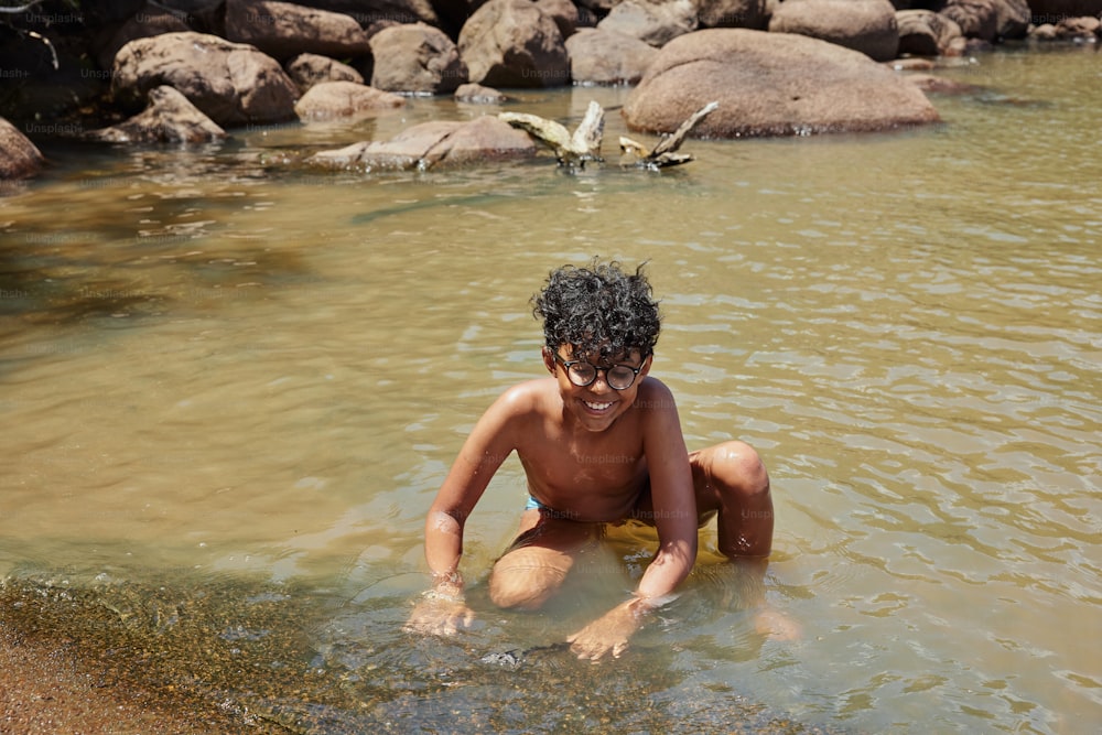 a young boy is playing in the water