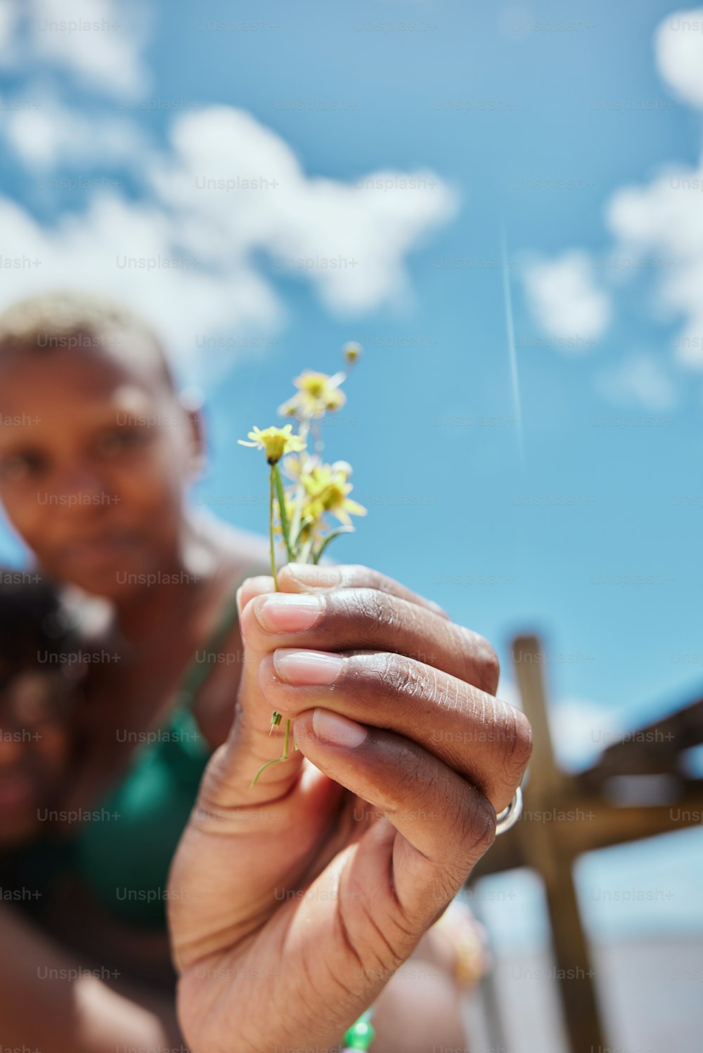 a woman holding a small flower in her hand