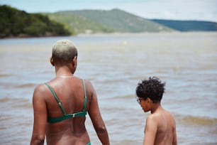 a couple of people that are standing in the water