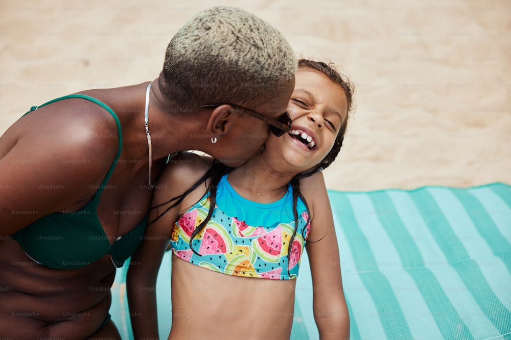 a woman and a little girl on a beach