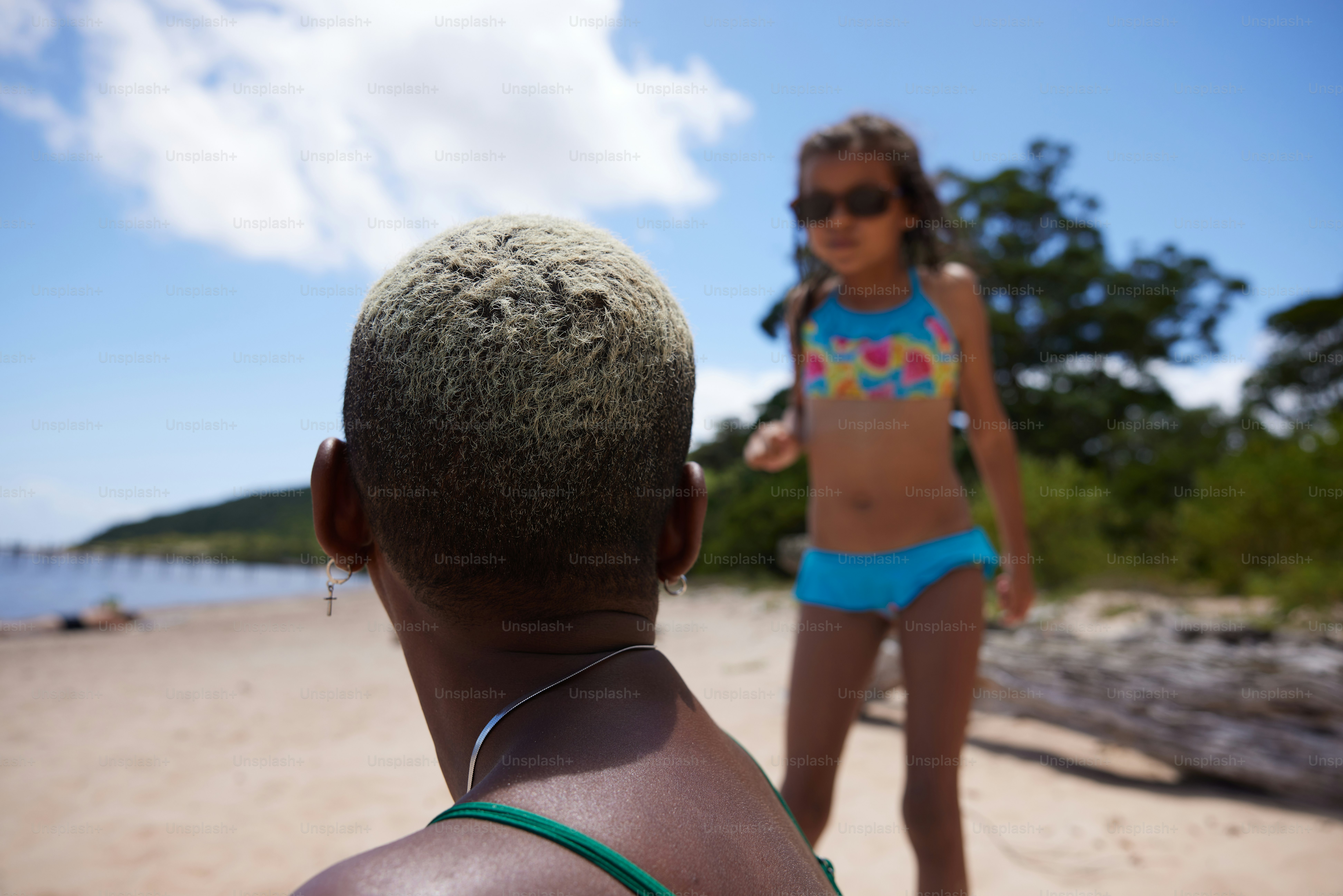 a woman in a bikini standing on a beach