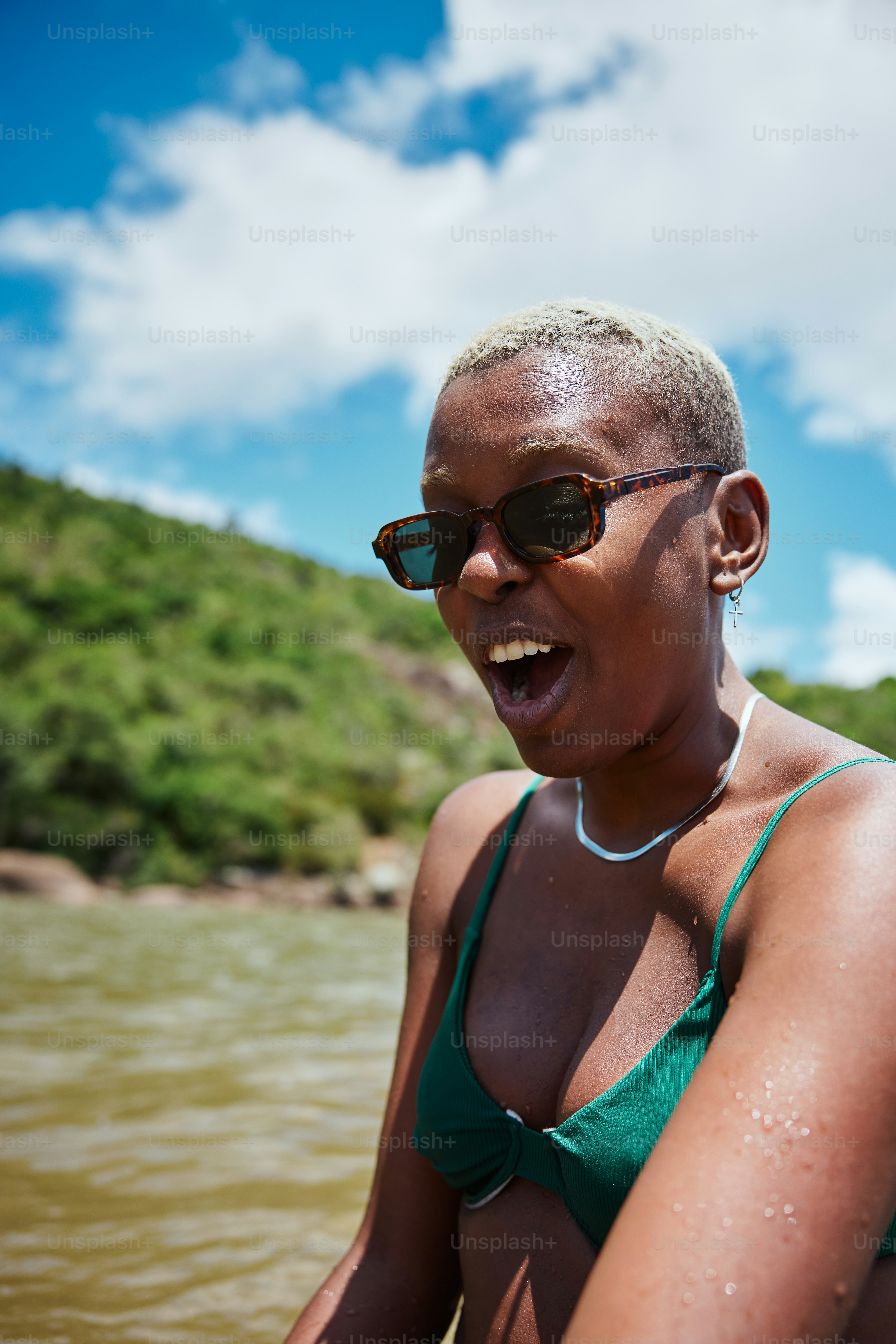 a woman in a green bikini standing in the water