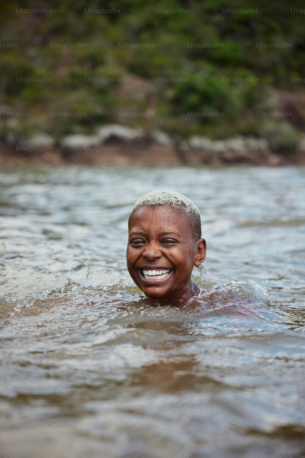 a woman swimming in a body of water