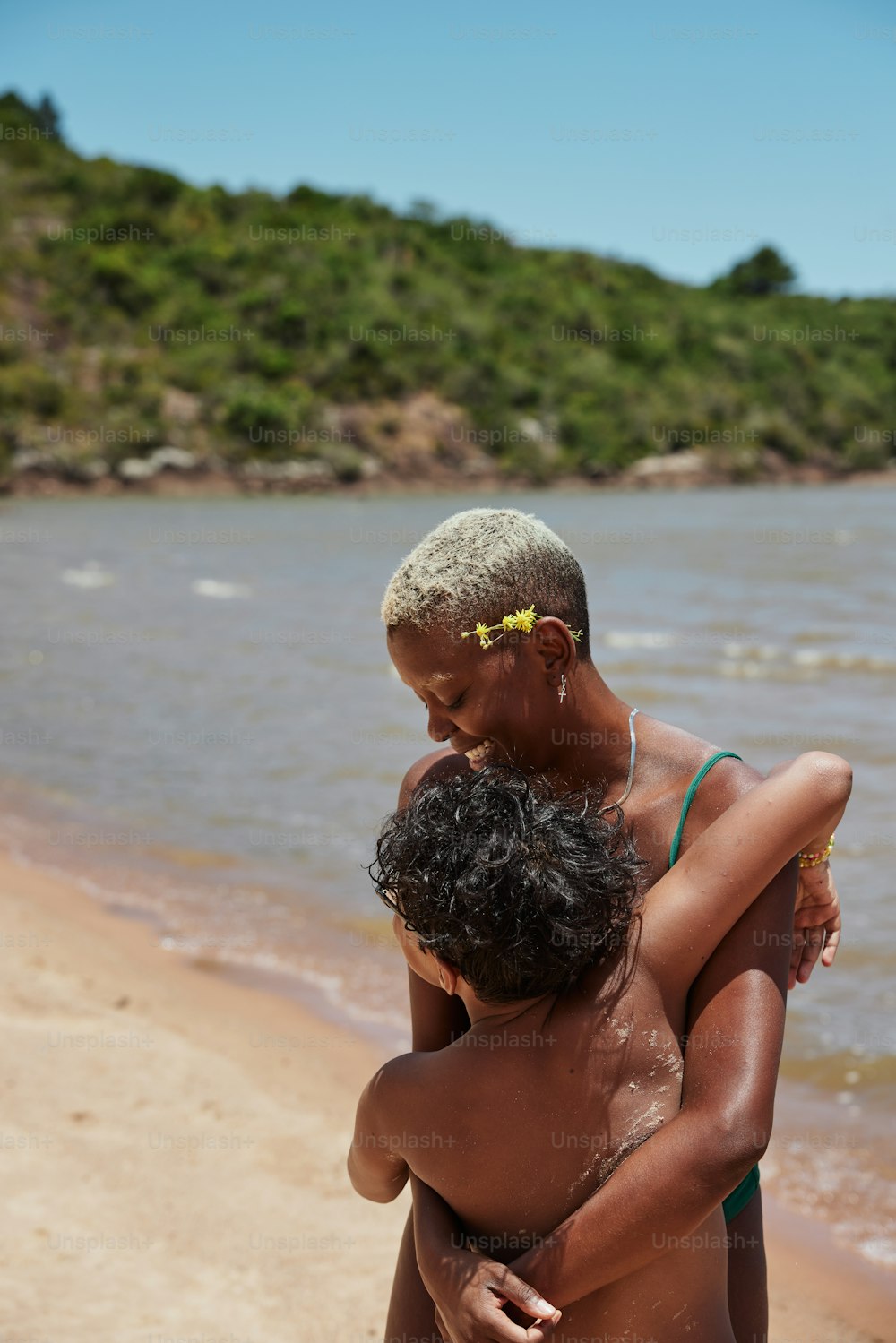 a couple of people that are standing in the sand