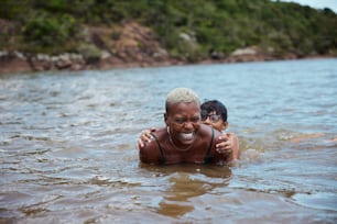 a woman and a boy are swimming in the water