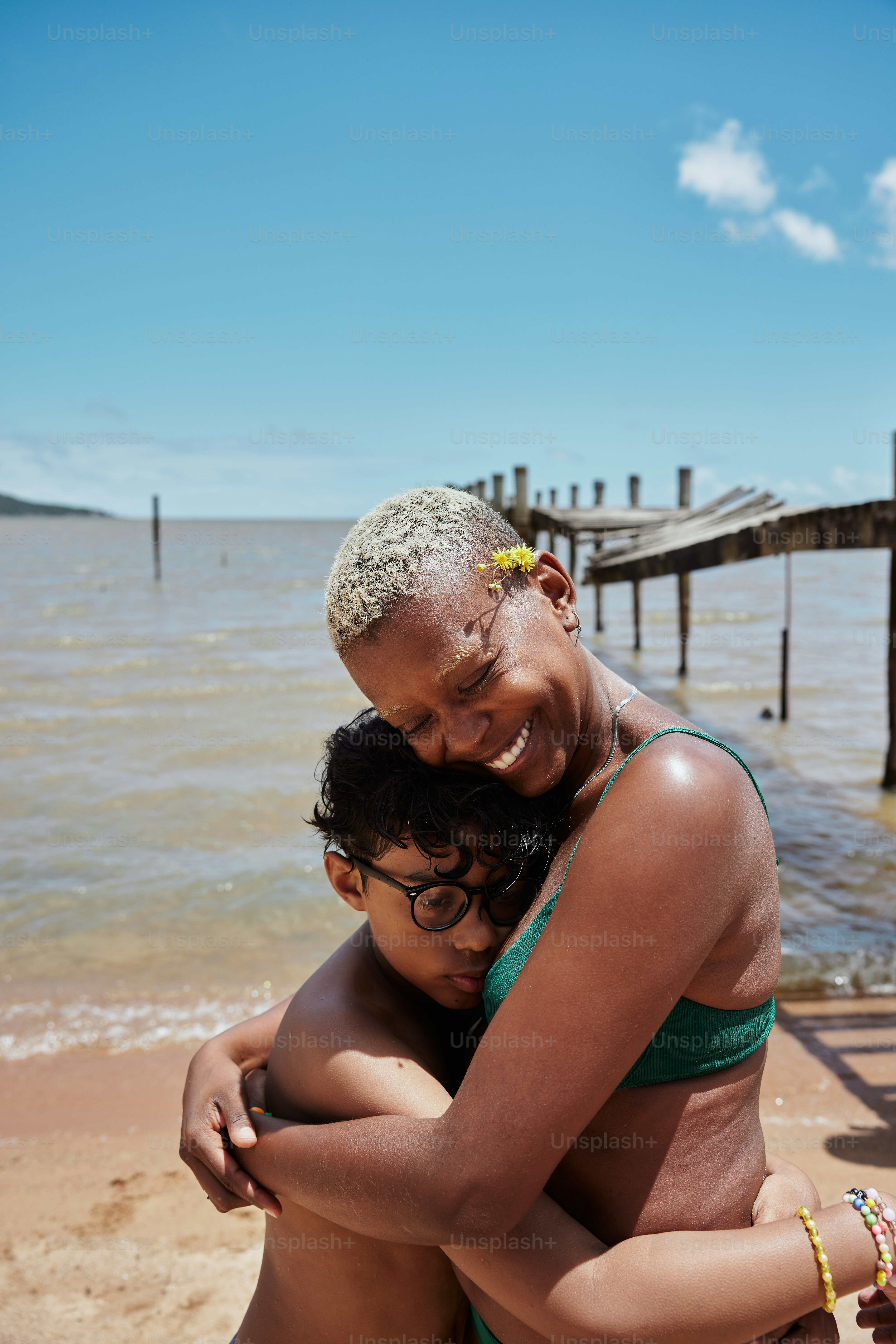 a woman hugging a man on the beach