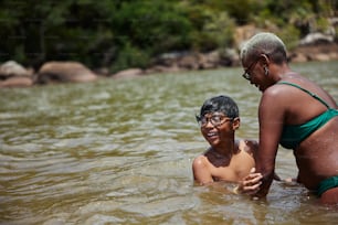 a woman and a boy in a body of water