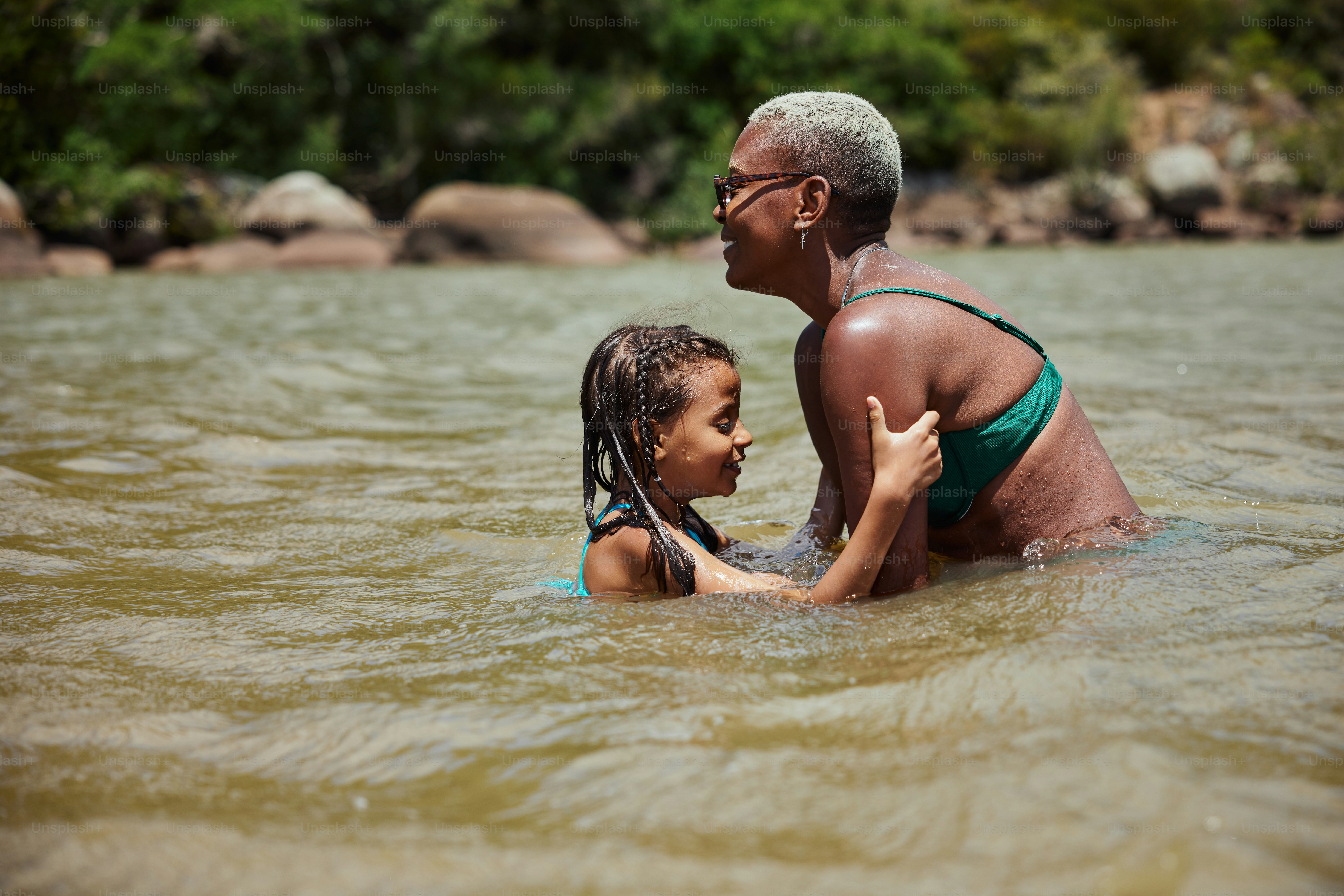 a woman and a child are in the water