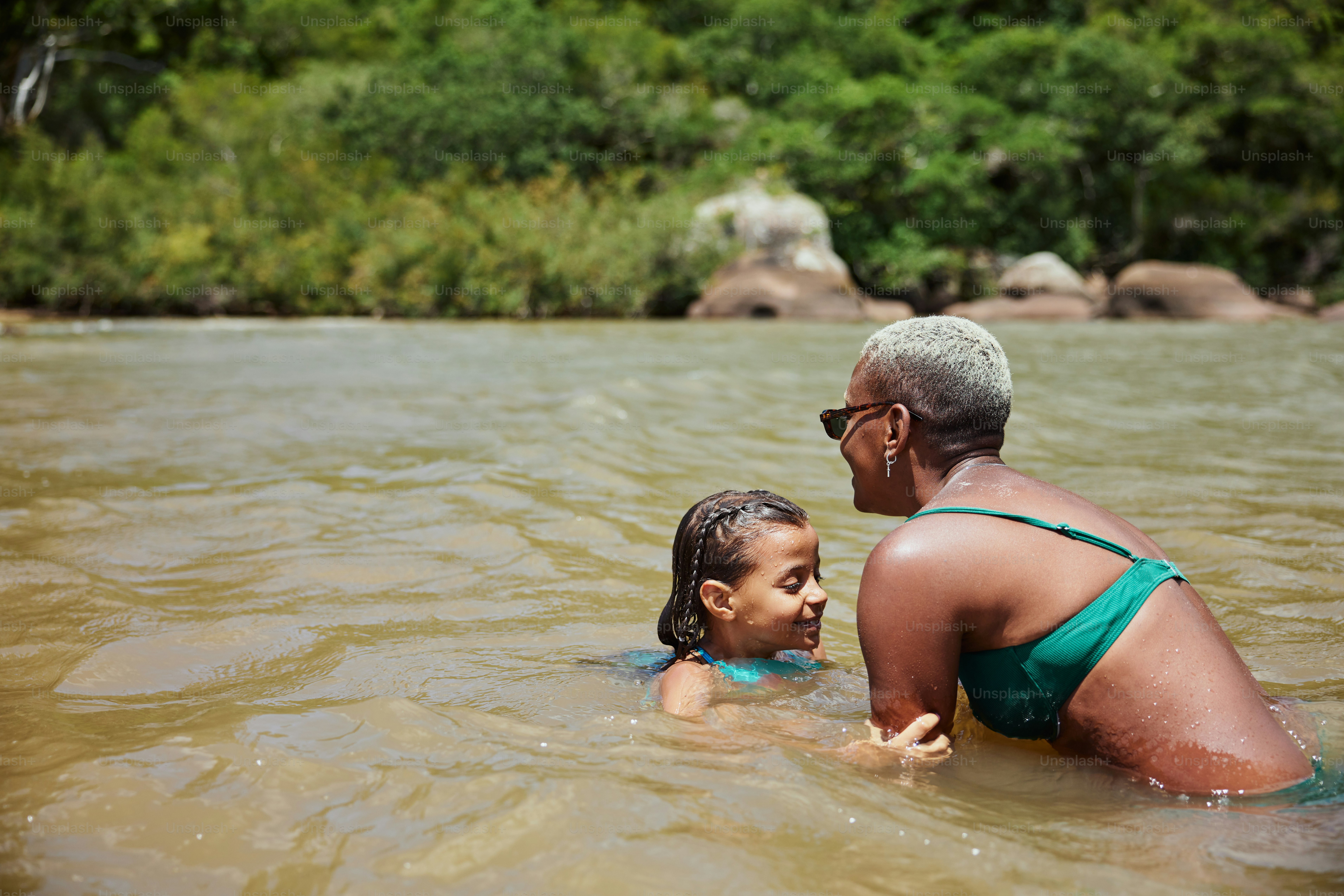 a woman and a child are in the water