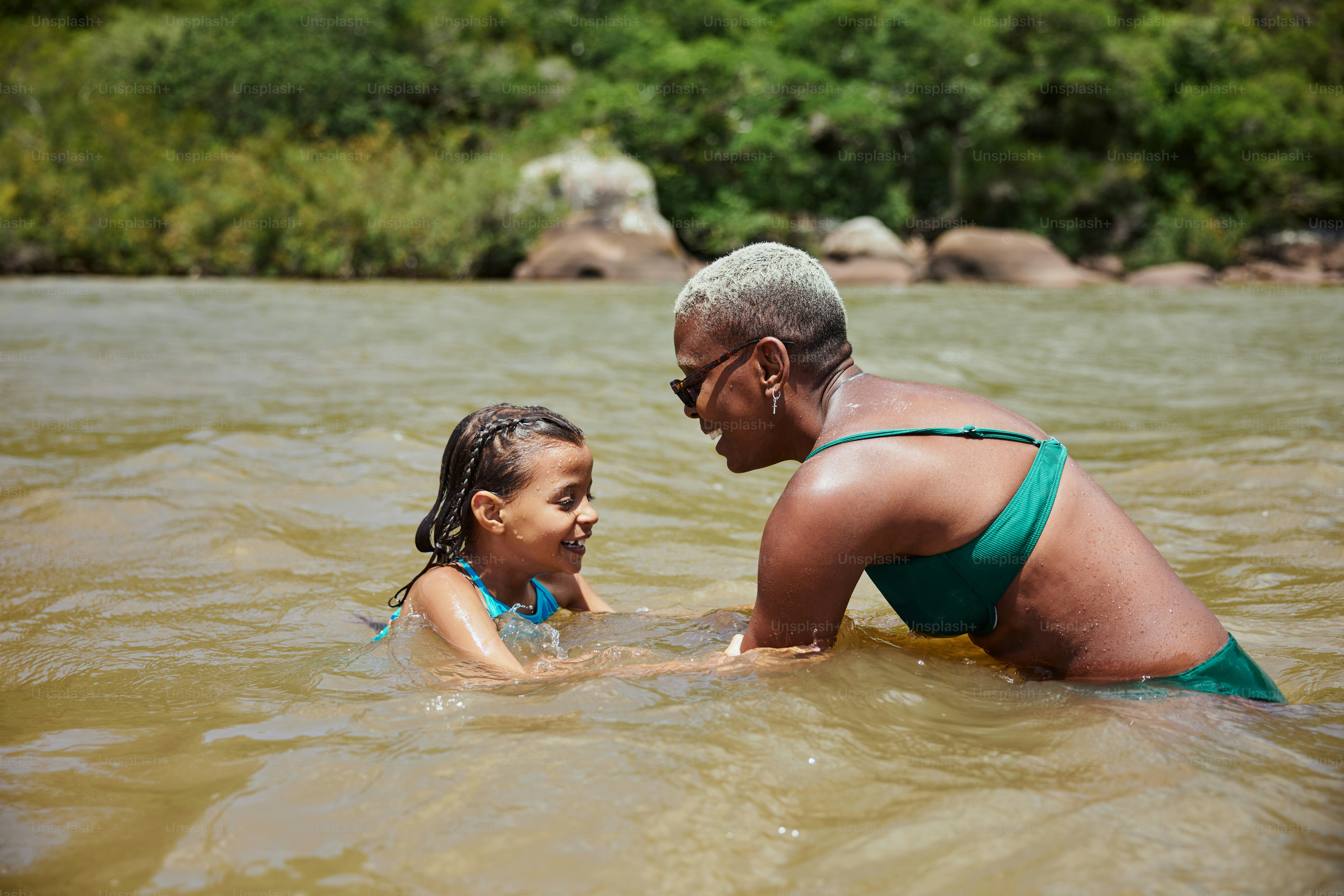 a woman and a child are in the water