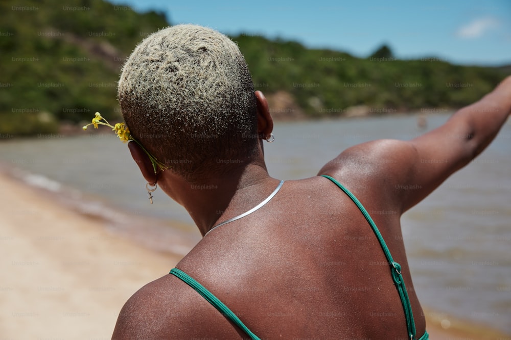 a woman with a flower in her hair on the beach