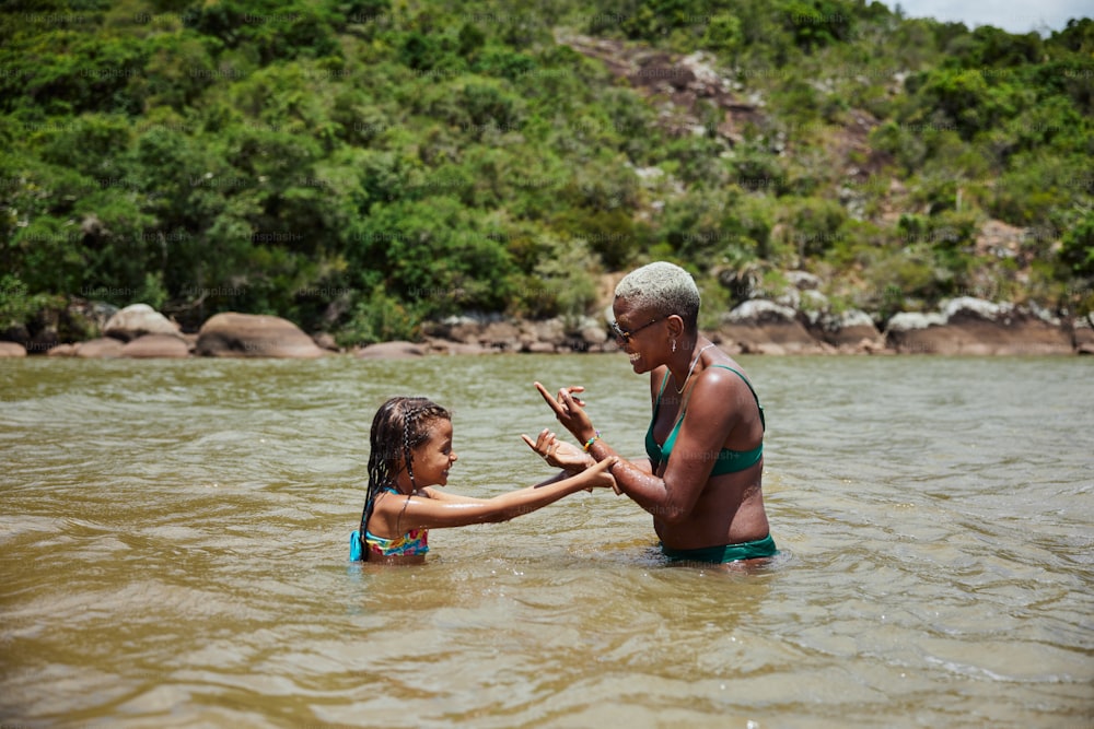 a man and a little girl in the water