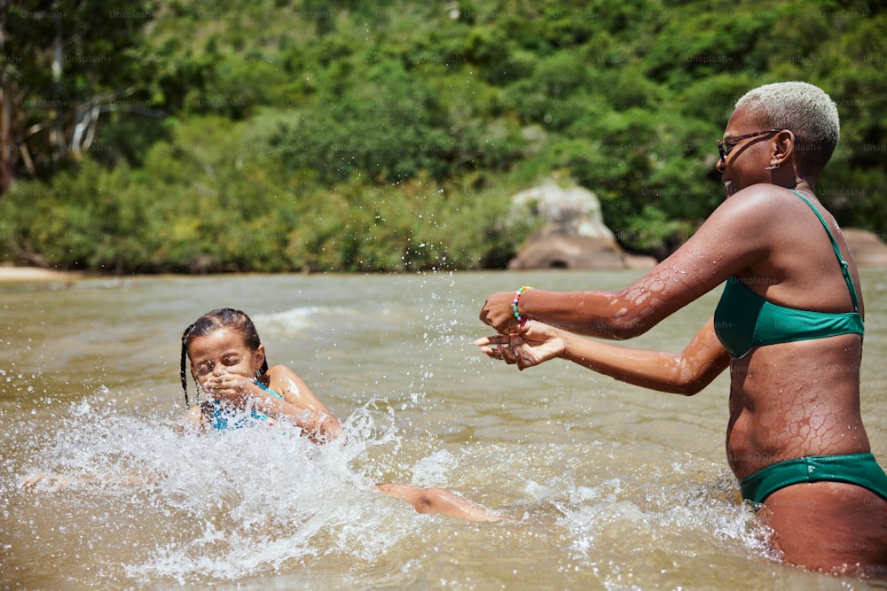 a woman and a child playing in the water