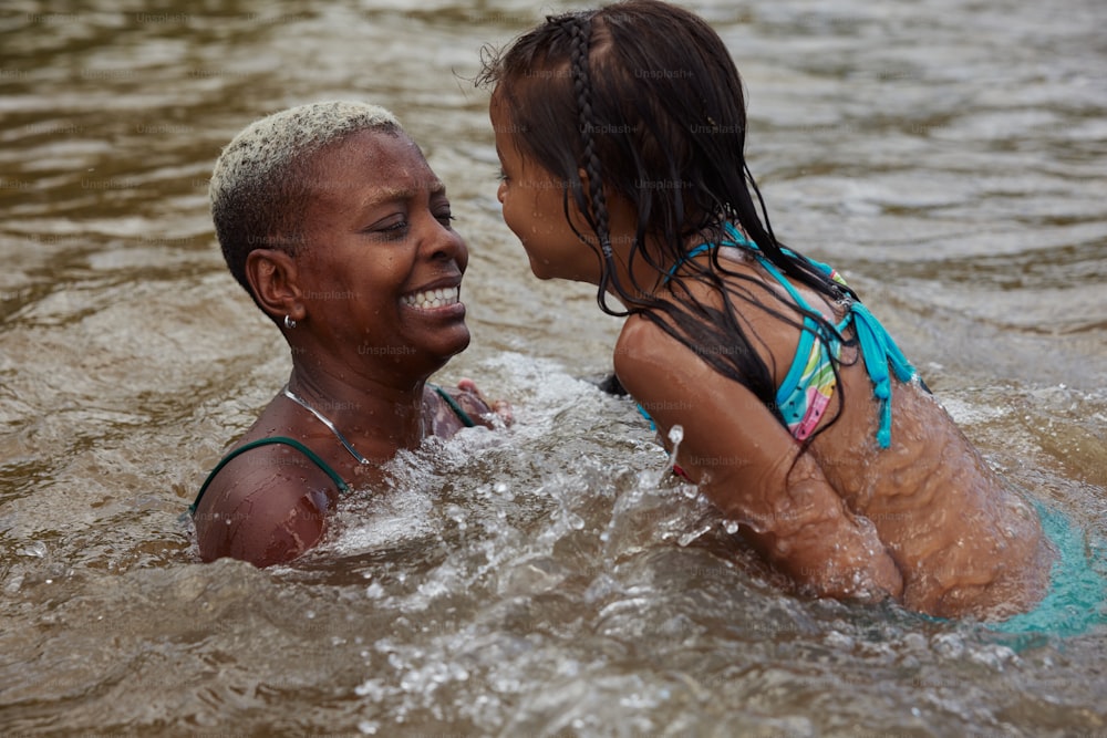 a woman and a child are in the water