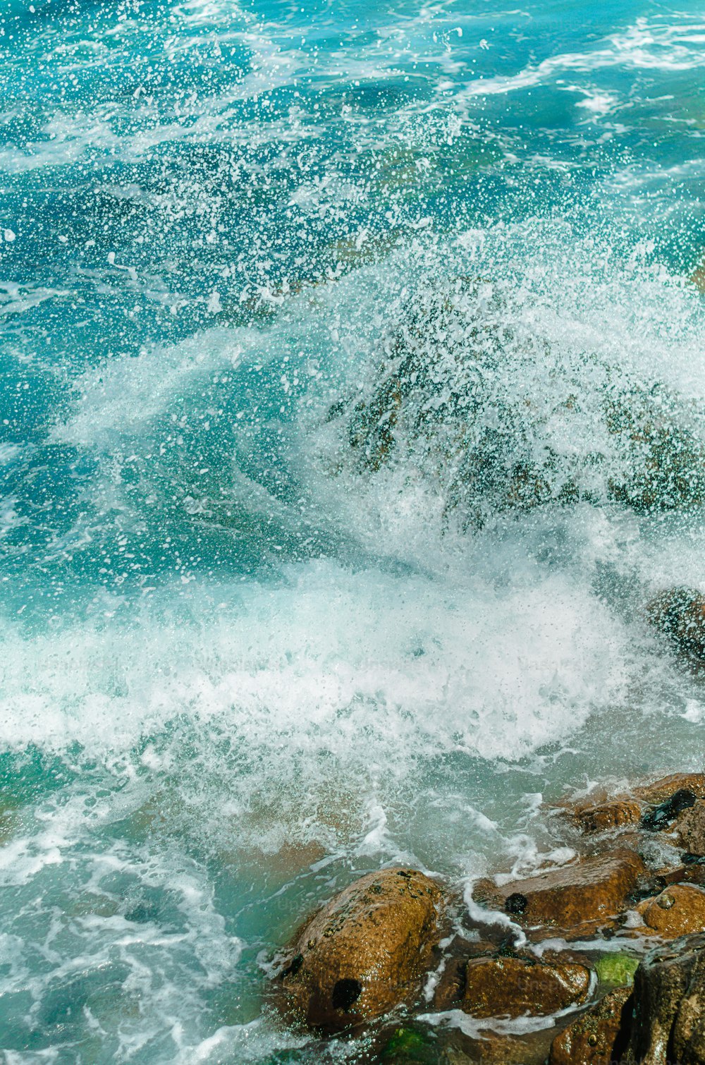 a man riding a wave on top of a surfboard