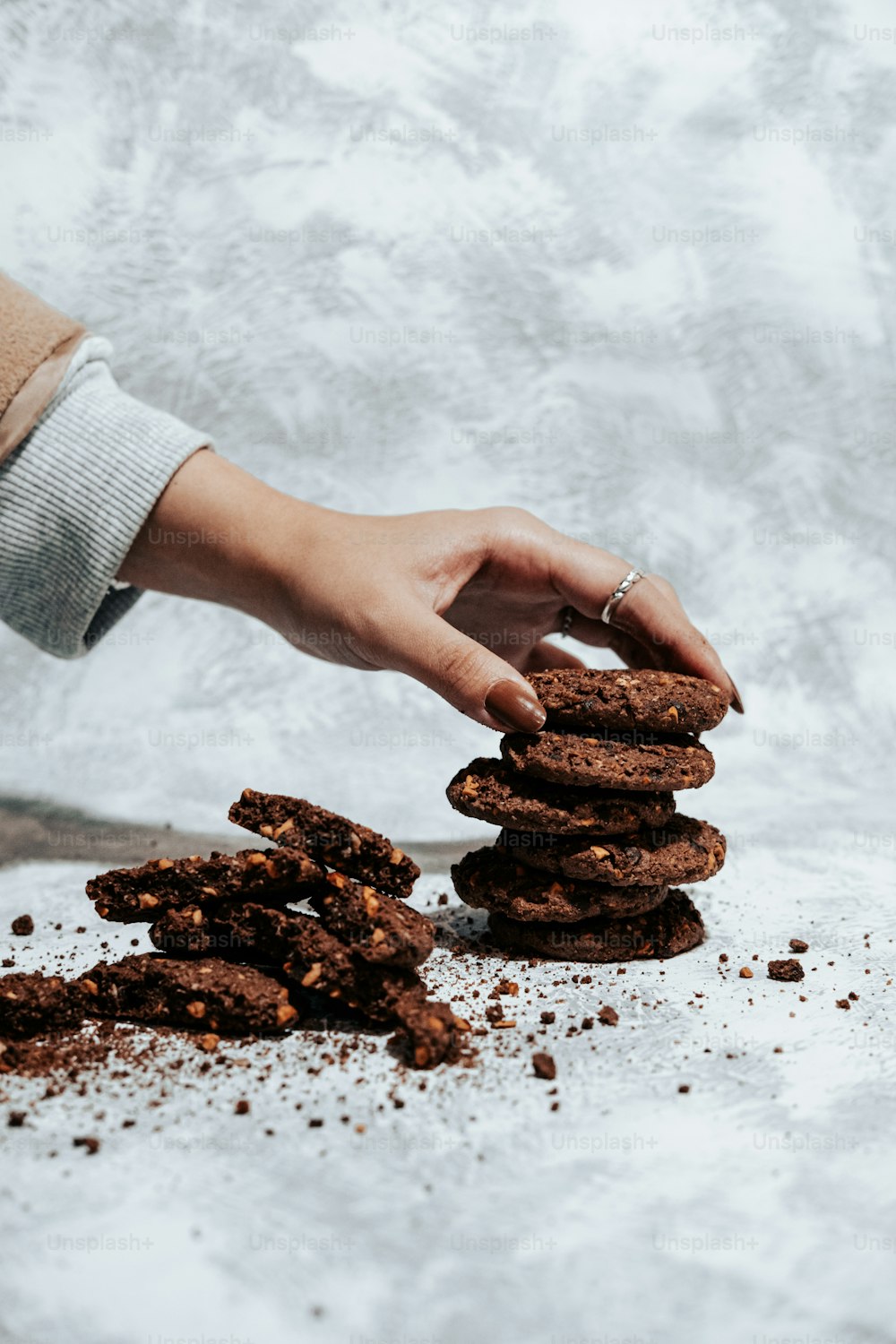 a person reaching for a stack of cookies
