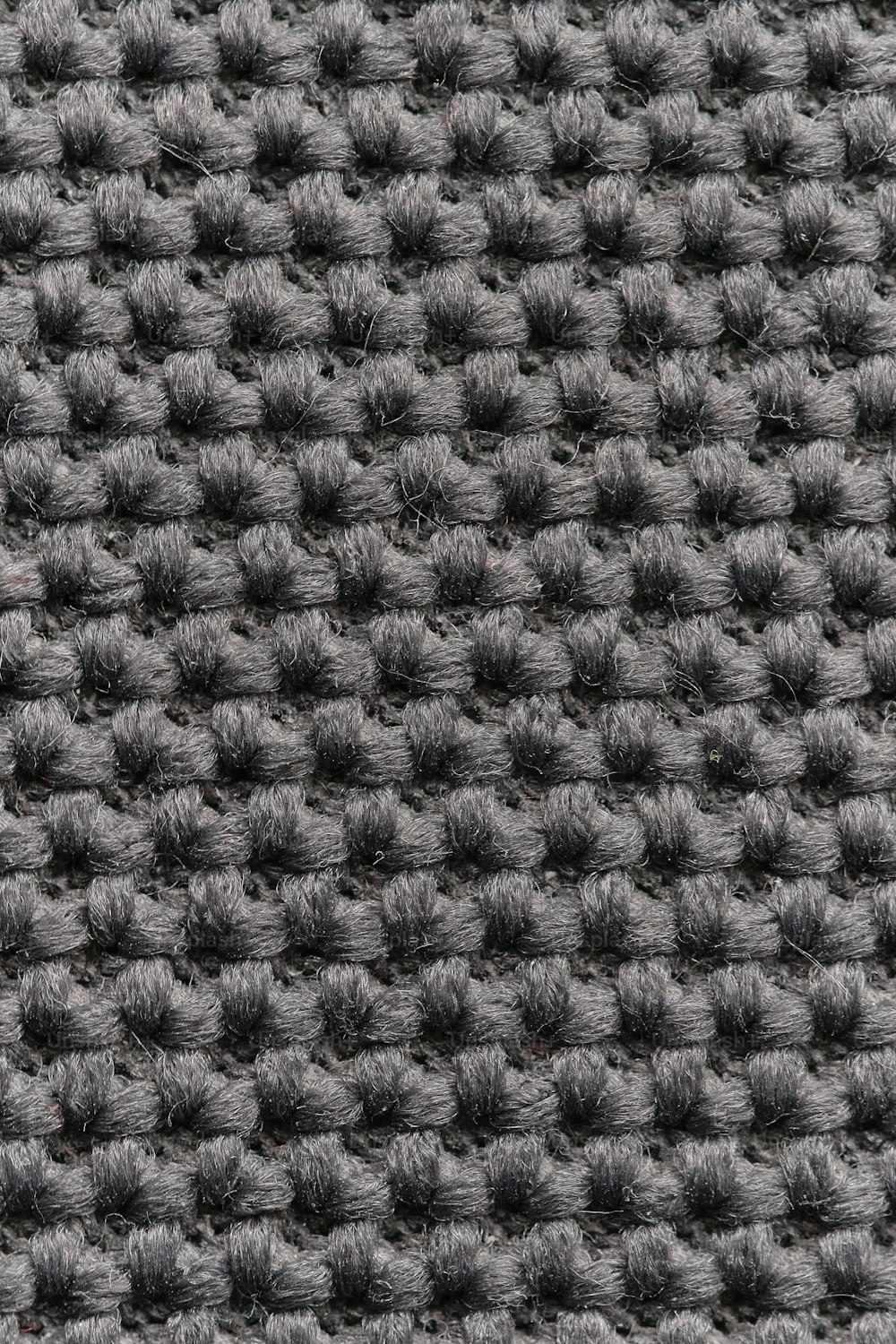 a black and white photo of a knitted surface
