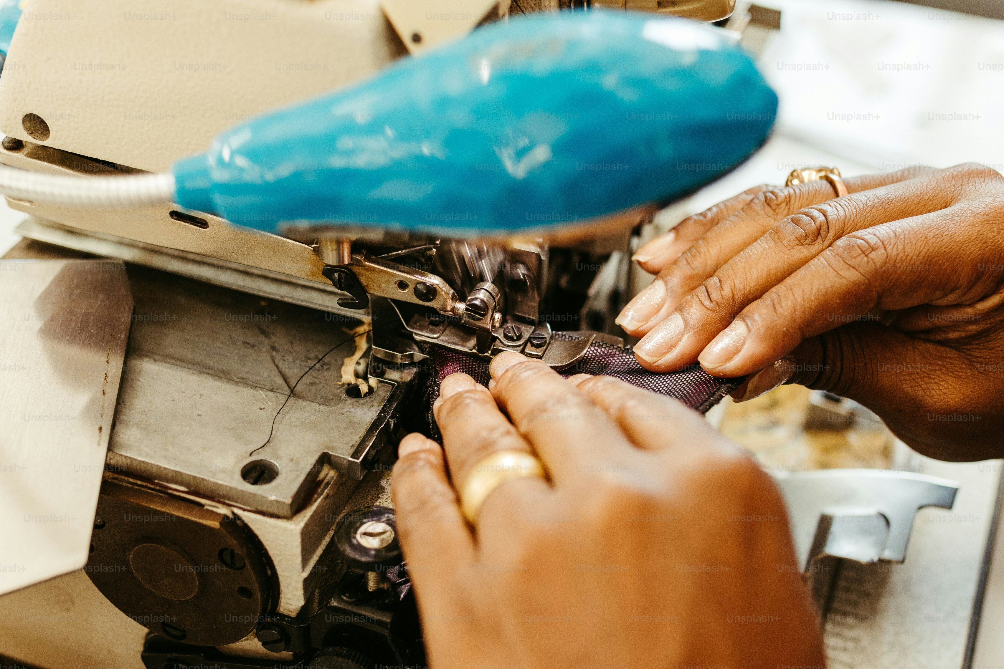 a woman is working on a sewing machine