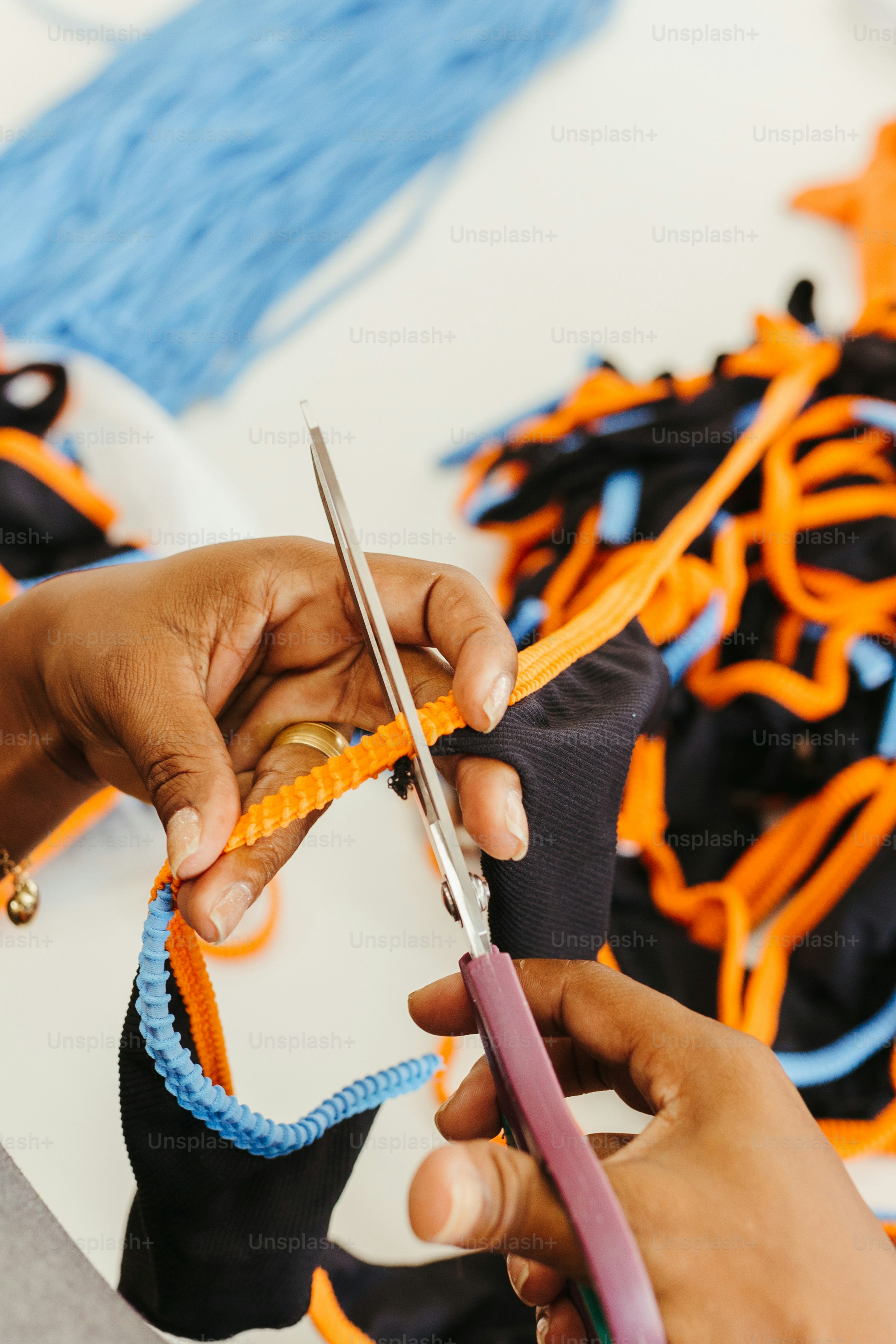 a person cutting a piece of fabric with a pair of scissors