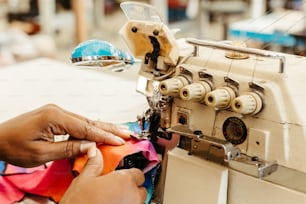 a person is working on a sewing machine