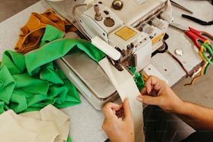 a person is working on a sewing machine