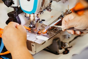 a person is working on a sewing machine