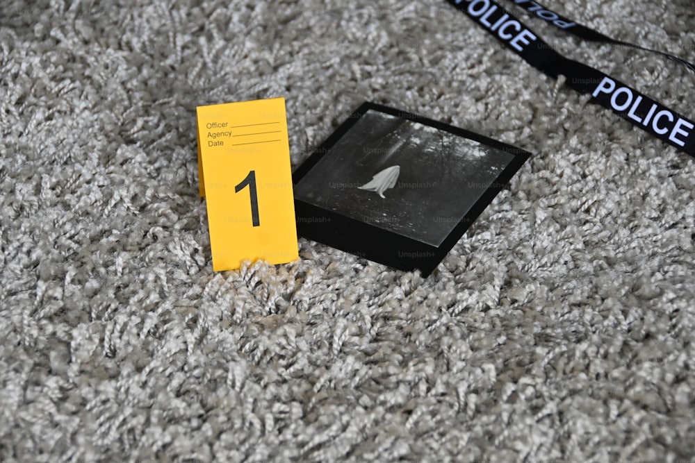 a black and white photo of a police badge on a carpet