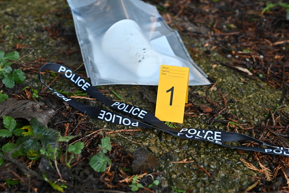 ein Polizeiband und ein Polizeiabzeichen auf dem Boden