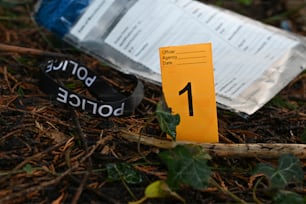 a piece of paper sitting on the ground next to a bottle of water