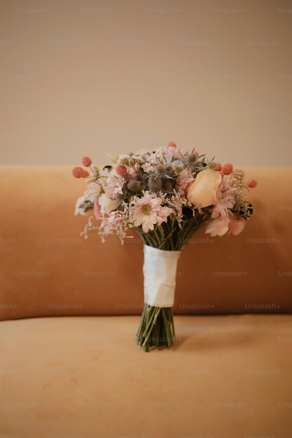 a bouquet of flowers sitting on top of a couch