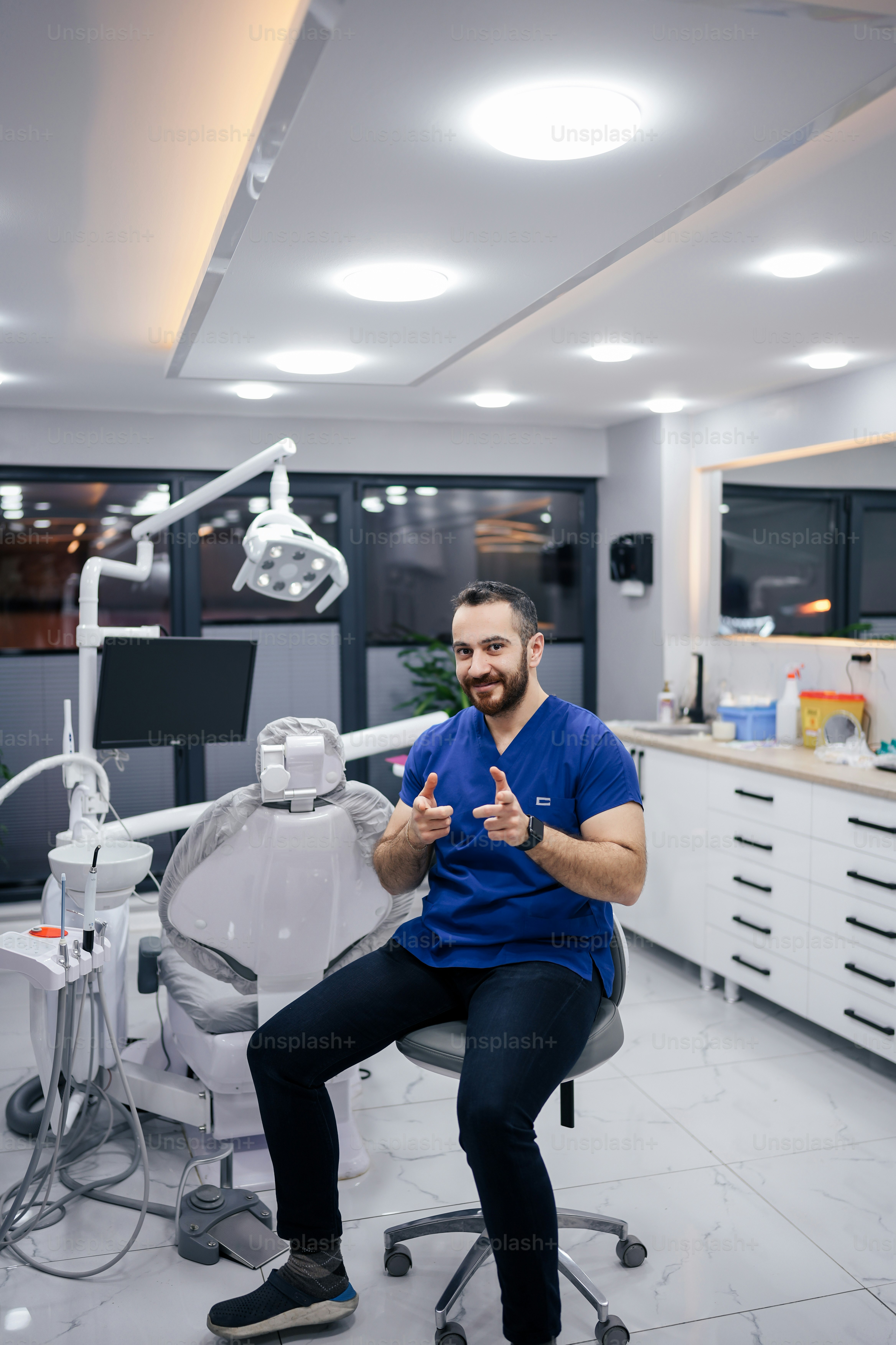 a man sitting on a chair in a dentist's office