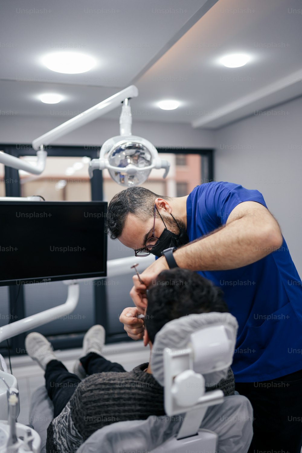 a man getting his teeth checked by a dentist