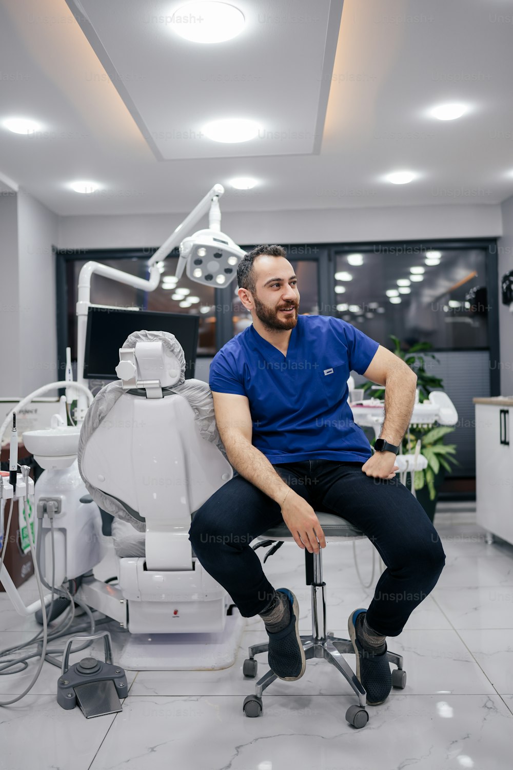 a man sitting on a chair in a dental office