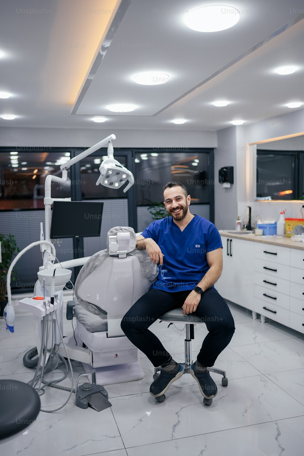 a man sitting on a chair in a dentist's office